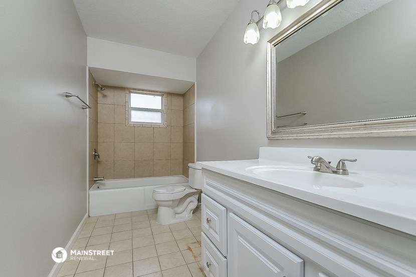 a bathroom with a sink and a toilet and a shower