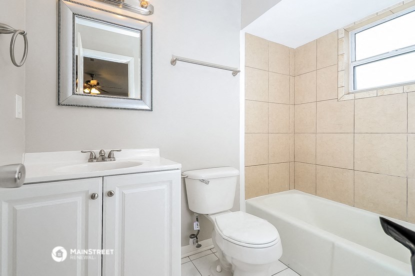 a bathroom with a sink toilet and a bath tub