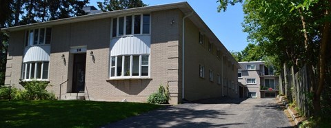 the side of a brick building with a driveway