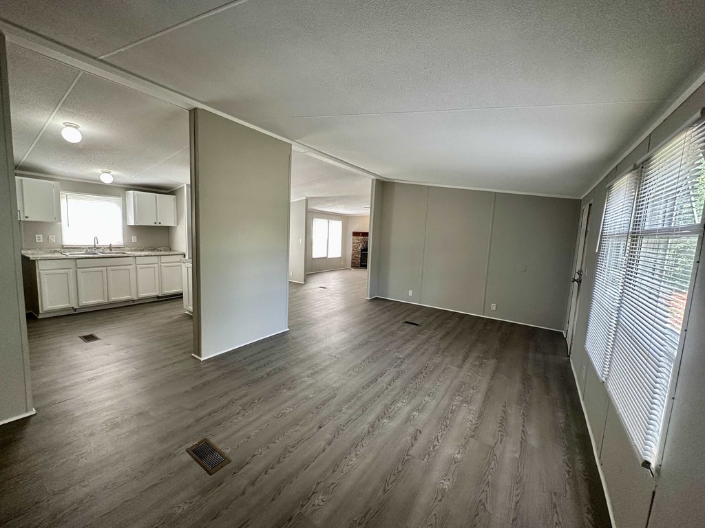 an empty living room and kitchen in an empty house
