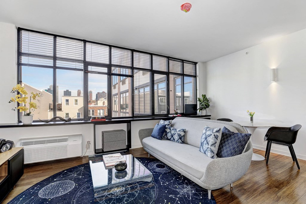 a living room with a couch and a large window
