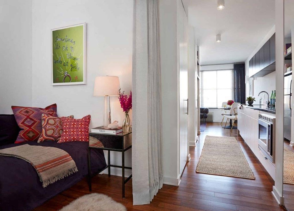 a small living room with a couch and a desk