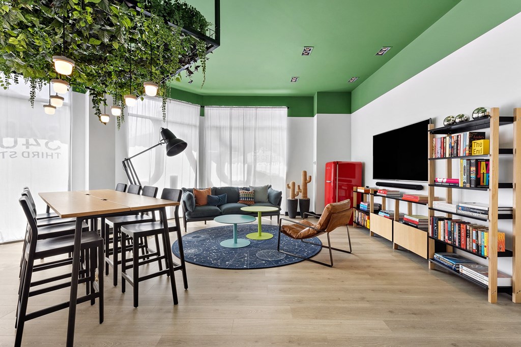 a living room with green walls and a table and chairs