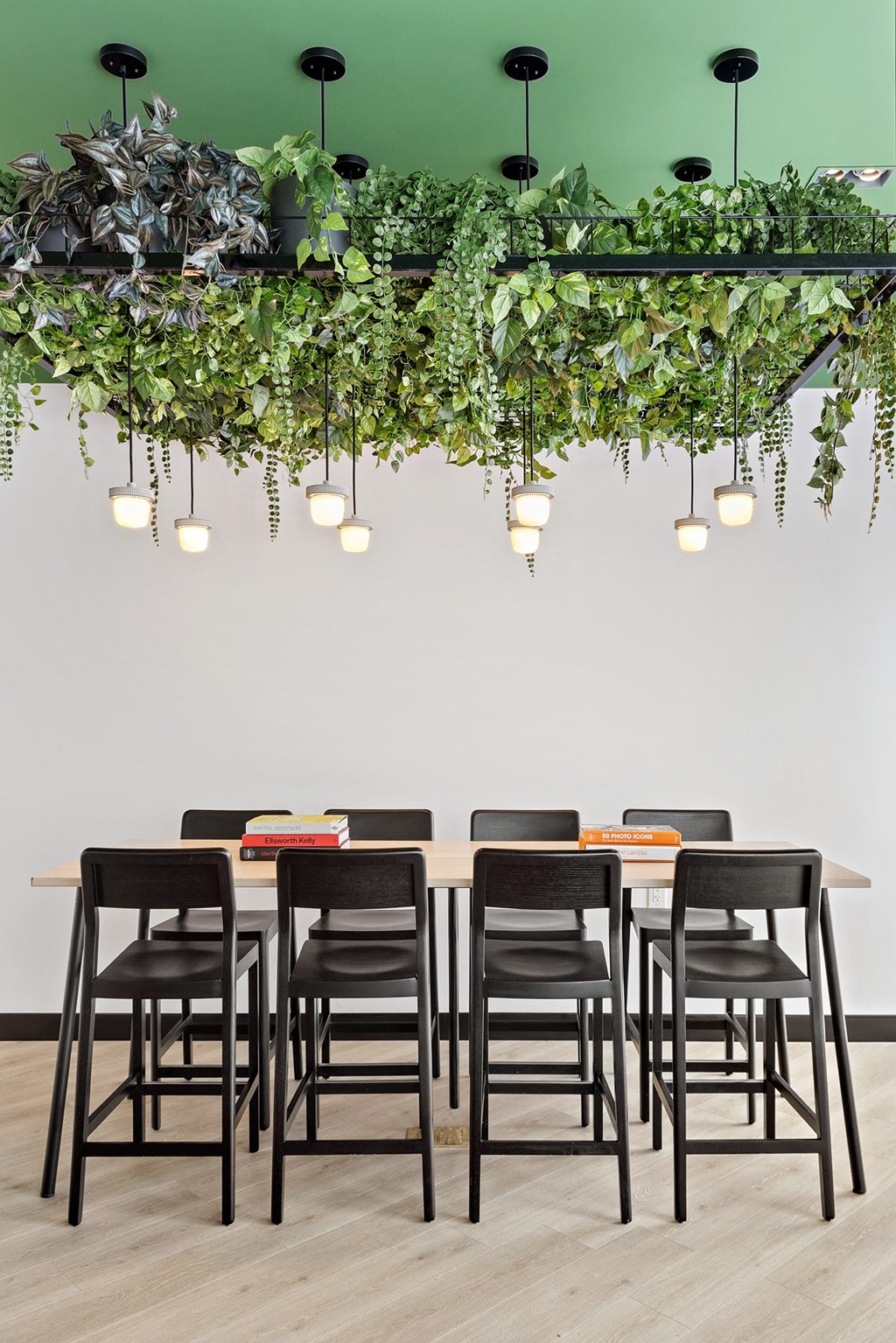 a dining room with a table and chairs under a green ceiling
