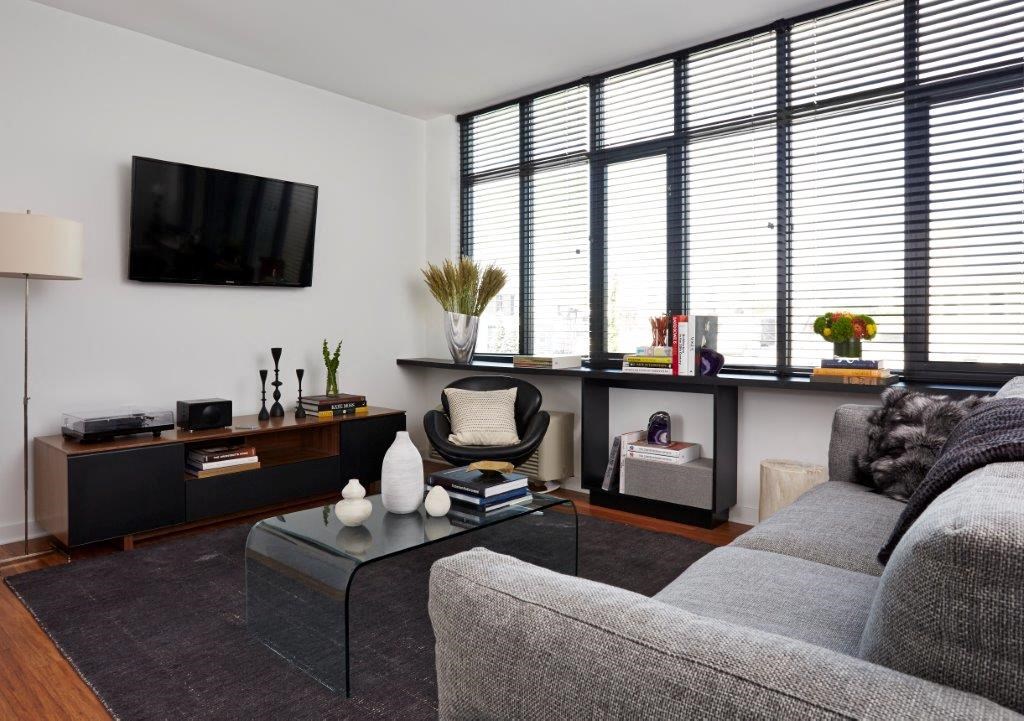 a living room with a couch and a table and a television