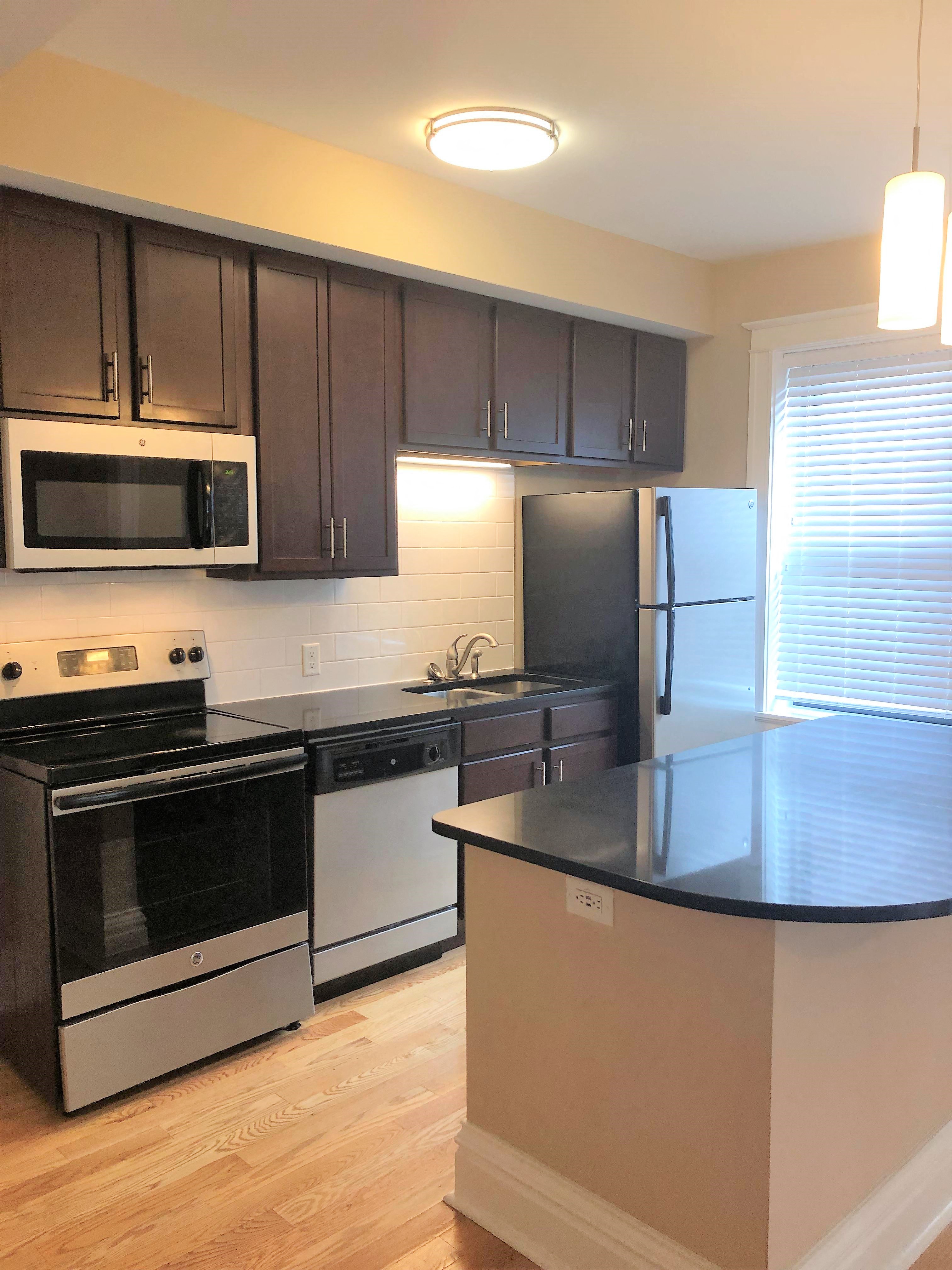a kitchen with stainless steel appliances and black counter tops