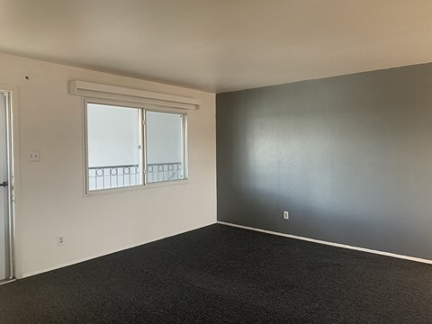 A room with a window and a door.