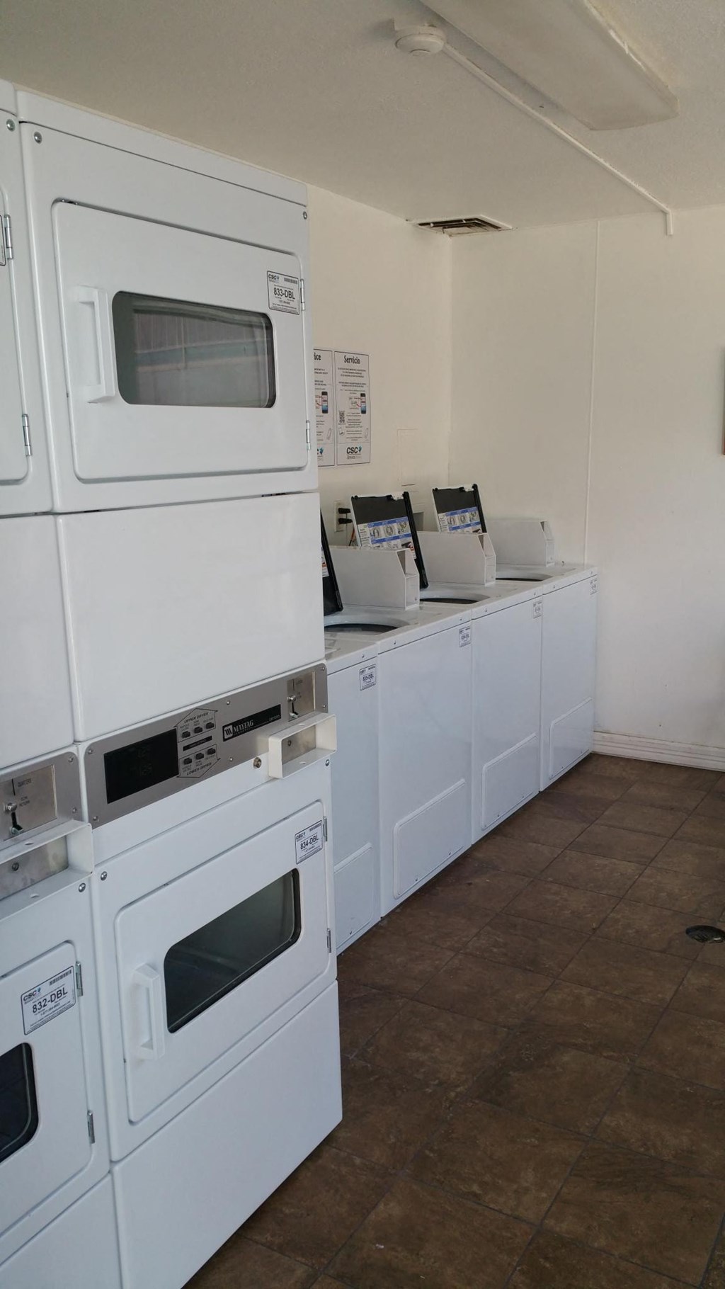 a row of stoves and microwaves in a room