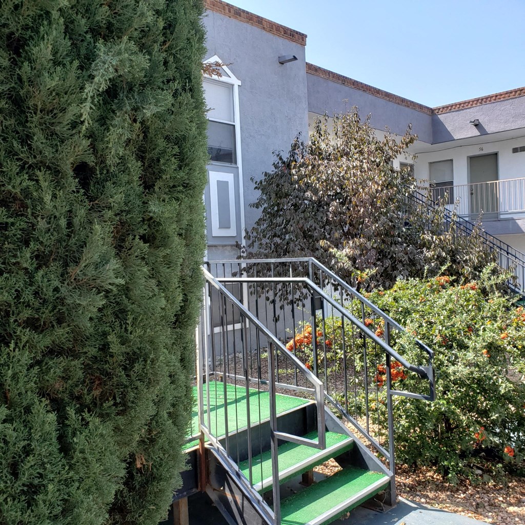 a staircase with green steps in front of an apartment building