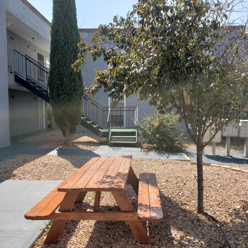 a picnic table in the courtyard of a building