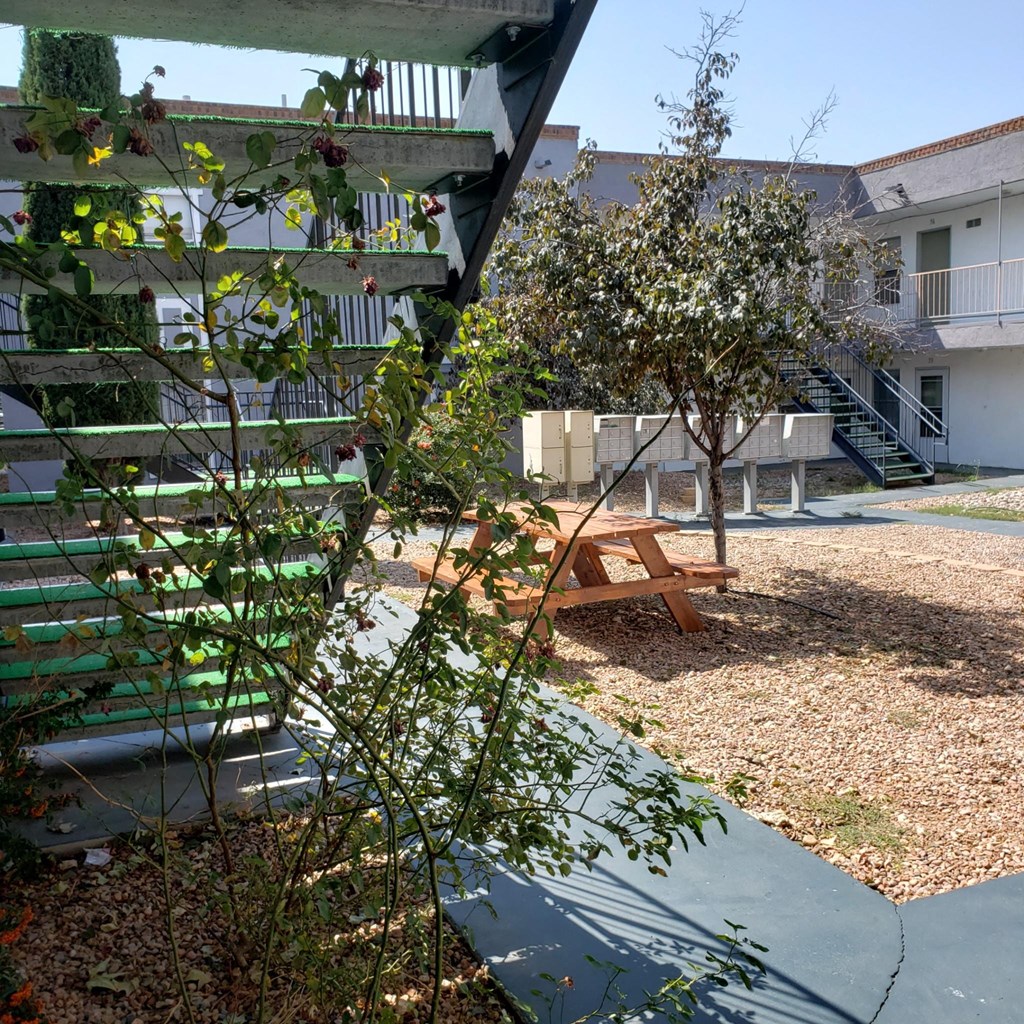 a view of a courtyard with a picnic table and stairs