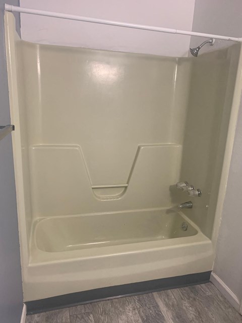 a bathroom with a shower and a toilet in it