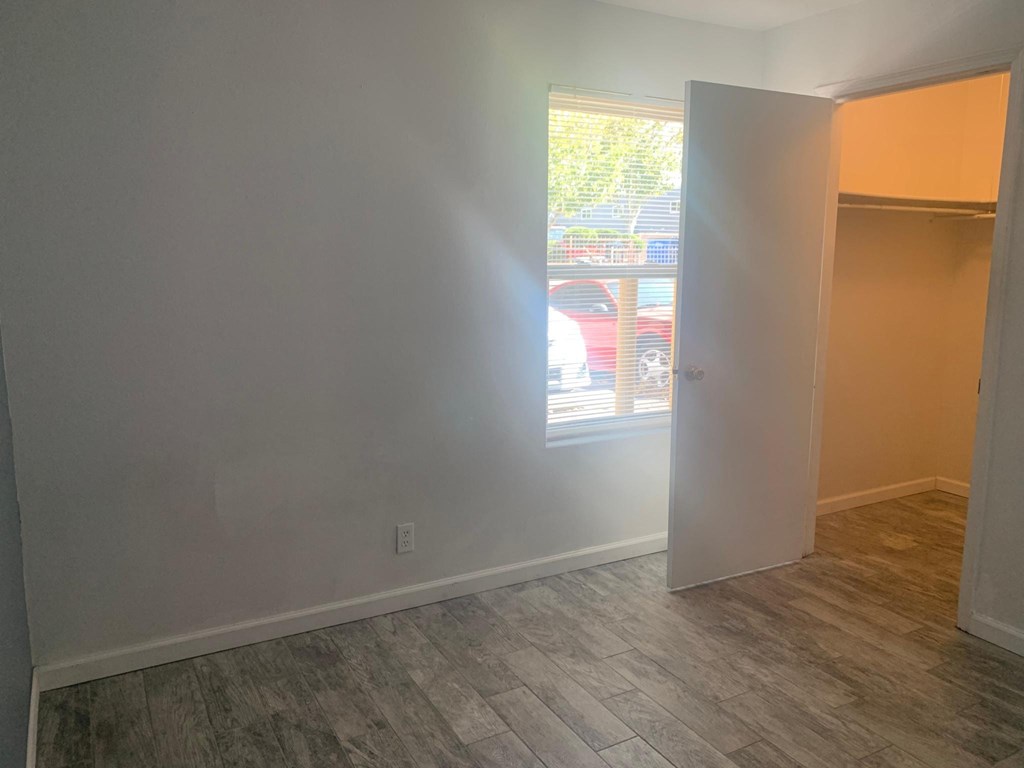 an empty room with a window and a door