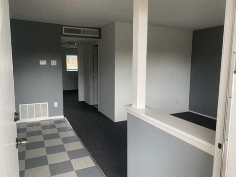 A room with a checkered floor and a window.