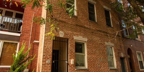 a brick building with a door and windows