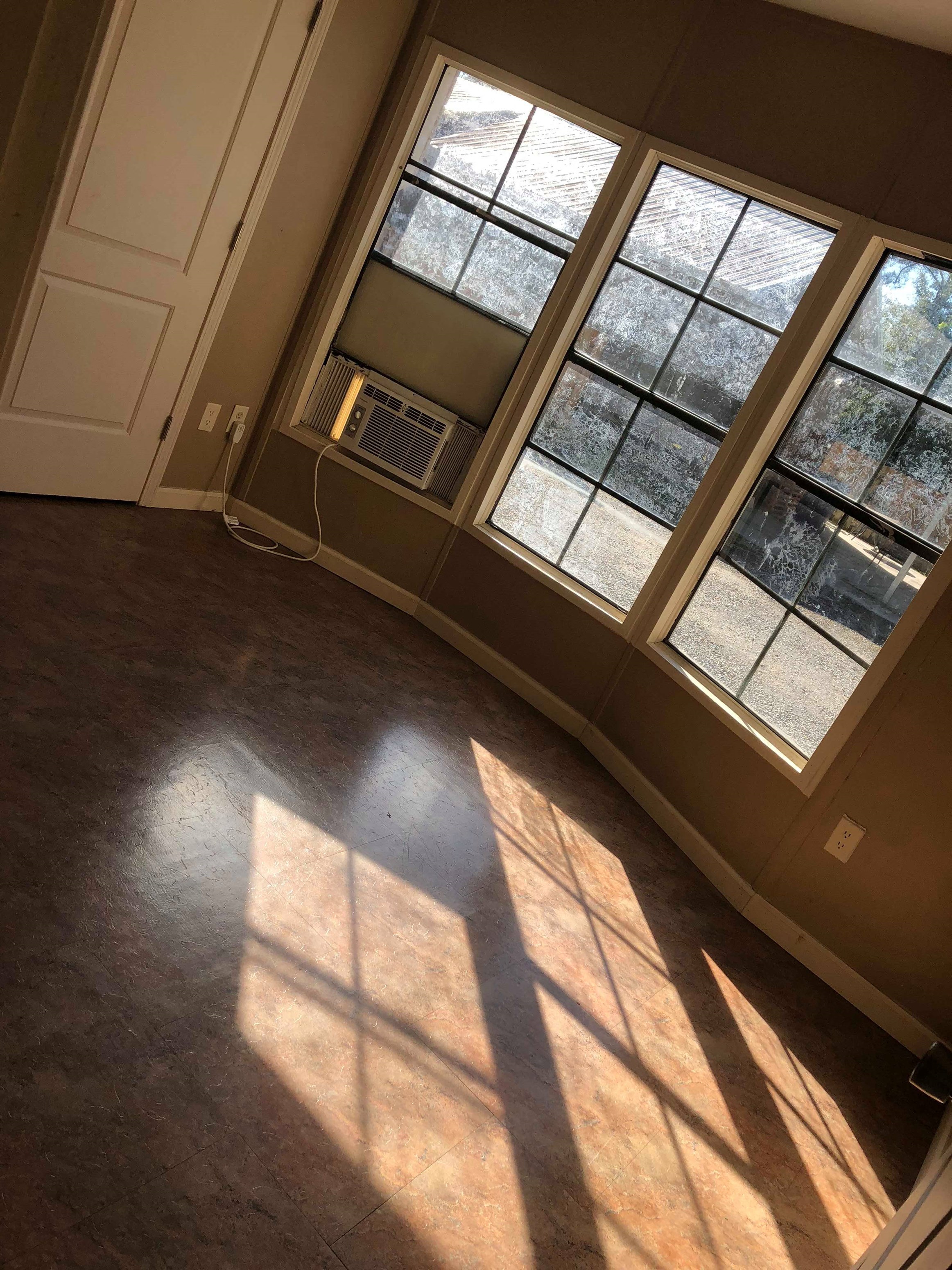 A room with a window and a door.