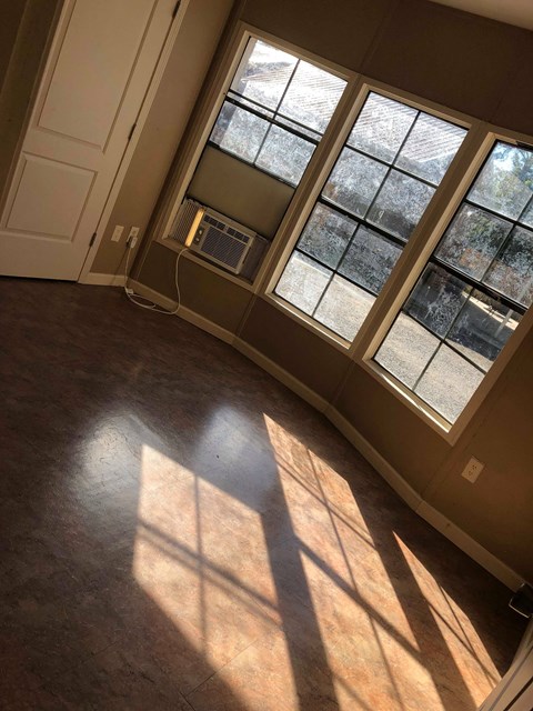 A room with a window and a door.