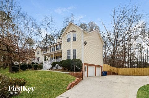 A house with a driveway and a garage is for sale.