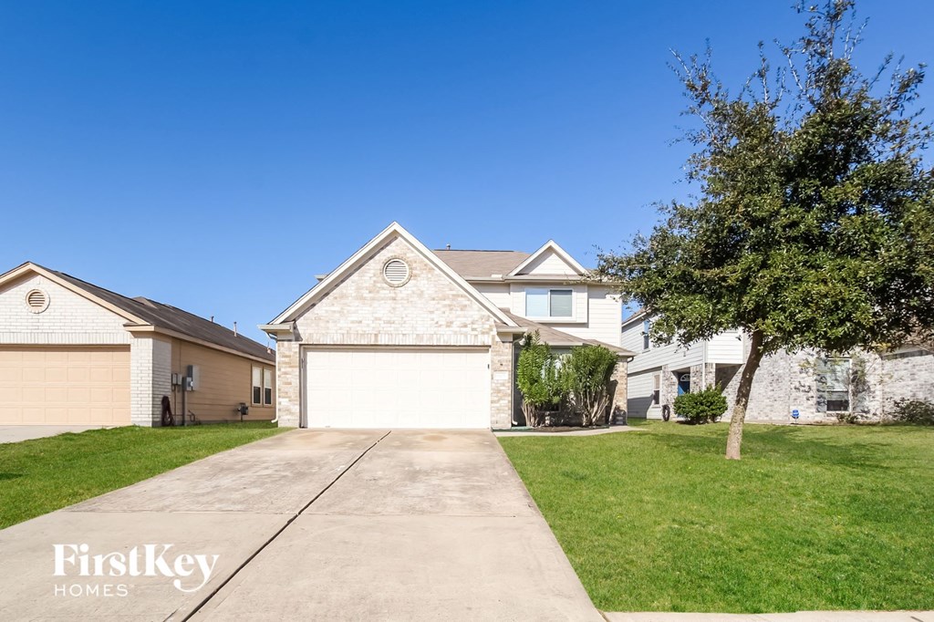 a white brick house with a white garage door
