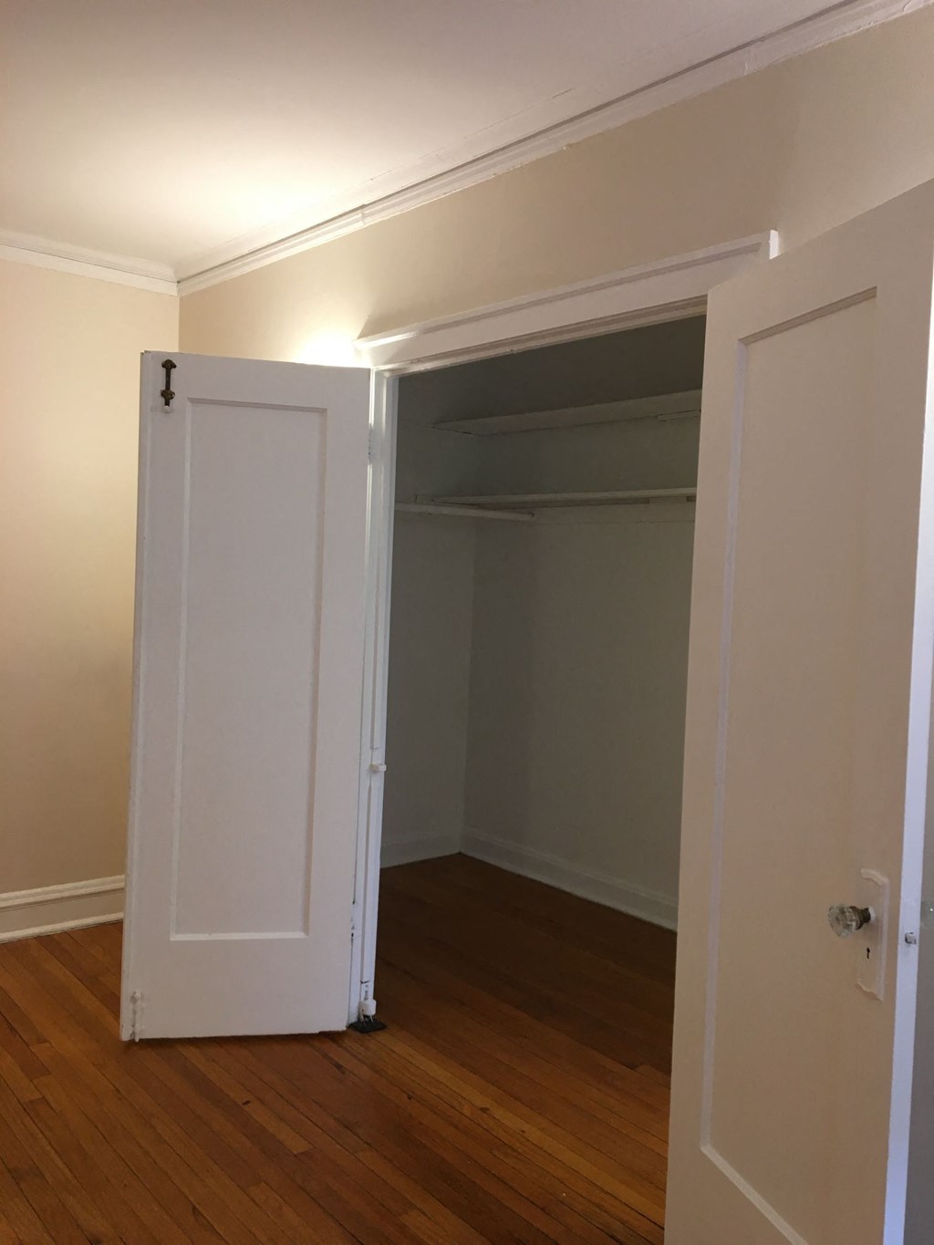 a room with a closet and an open door