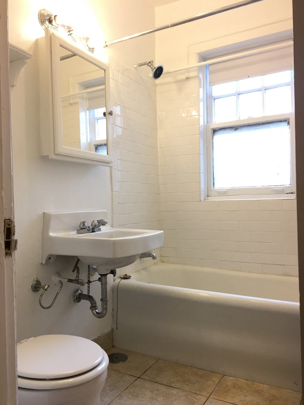 a small bathroom with a sink toilet and bath tub