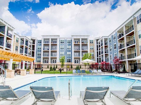a swimming pool in front of an apartment building