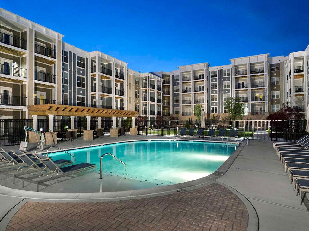 a swimming pool in front of an apartment building