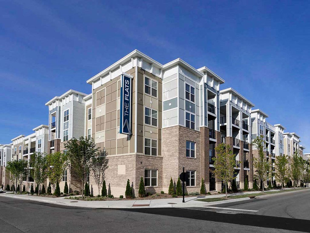 a rendering of a building on a street with trees
