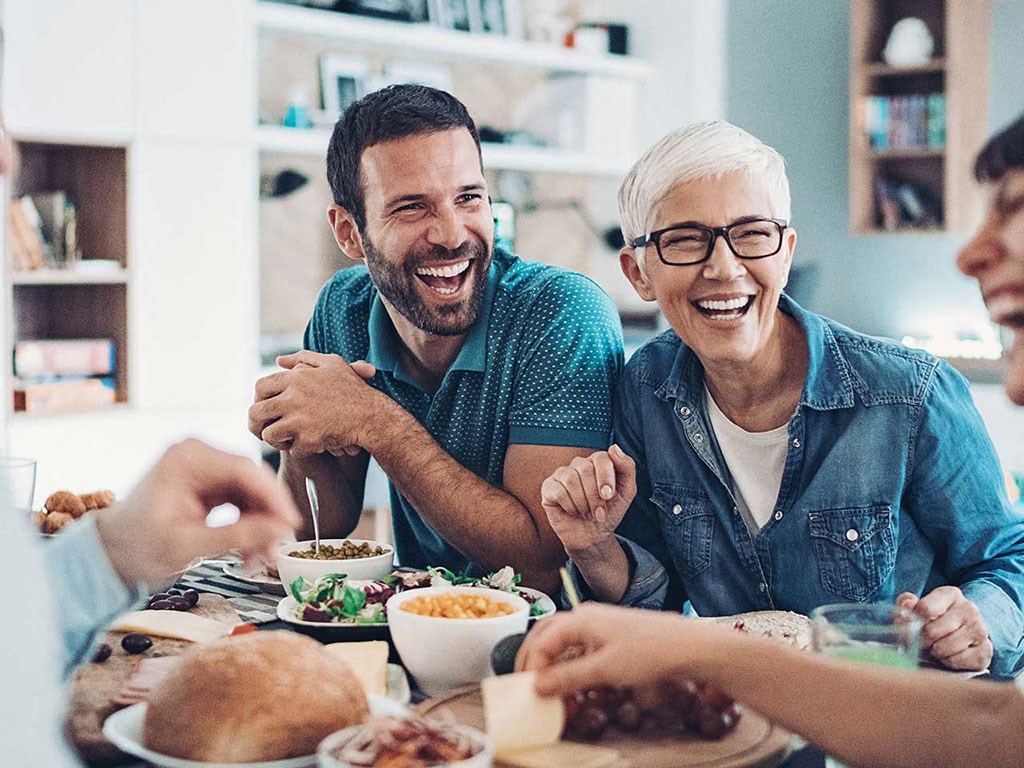 a group of people sitting at a table eating food