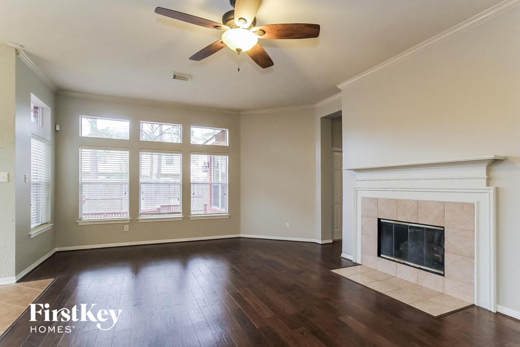 A room with a fireplace and a ceiling fan.