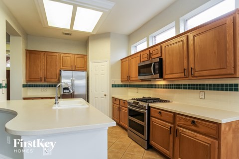 A kitchen with wooden cabinets and a white countertop.