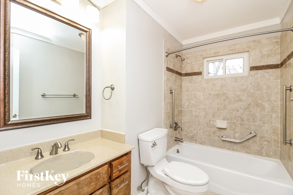 a bathroom with a sink toilet and a bath tub