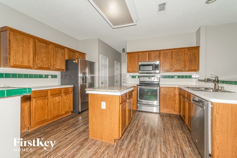 A kitchen with wooden cabinets and stainless steel appliances.
