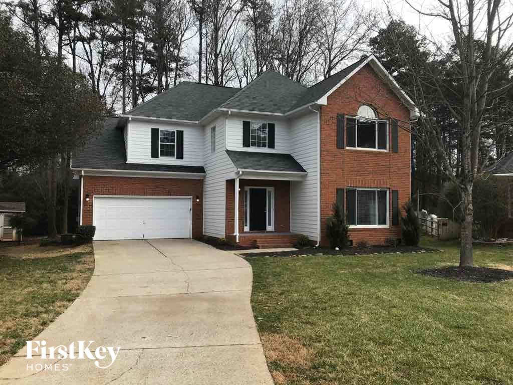 A brick house with a garage door and a driveway.