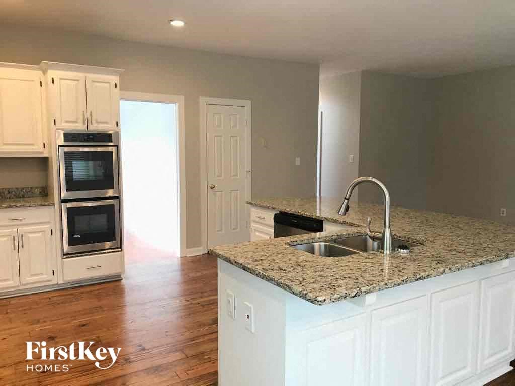 A kitchen with a granite countertop and a sink.