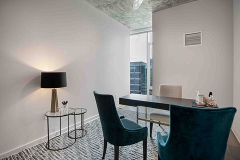 a dining room with a table and chairs and a window