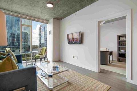 a living room with a couch and a glass table