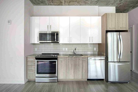 a kitchen with stainless steel appliances and white cabinets