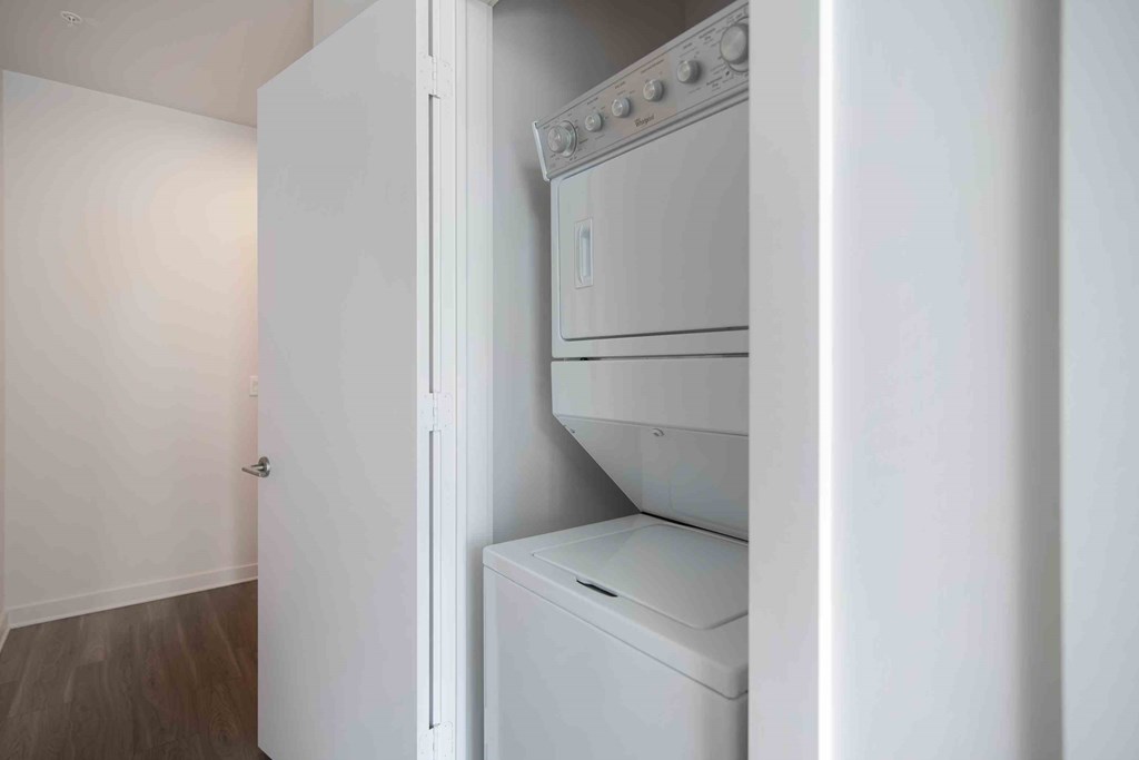 a white washer and dryer in a room with a closet