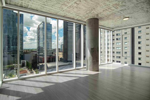 an open living room with a view of the city