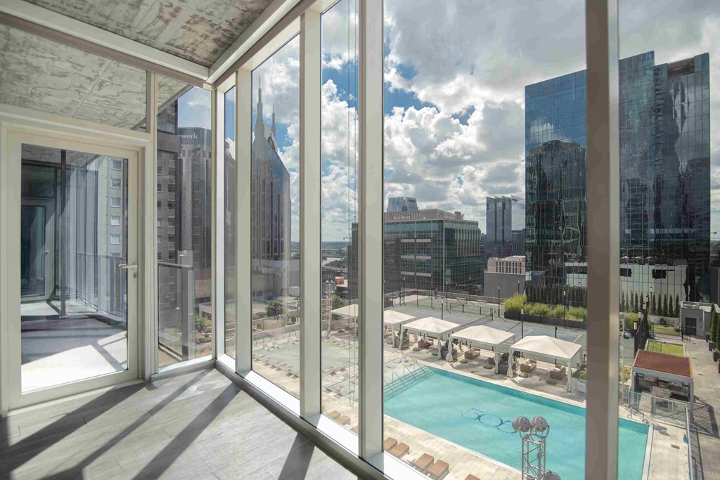 a view of a pool and a city from a balcony