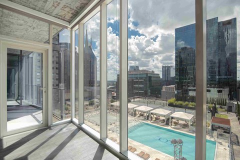 a view of a pool and a city from a balcony