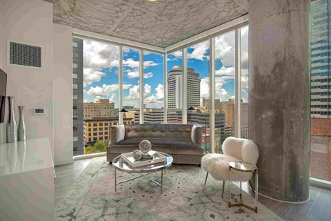 a living room with a couch and a view of the city