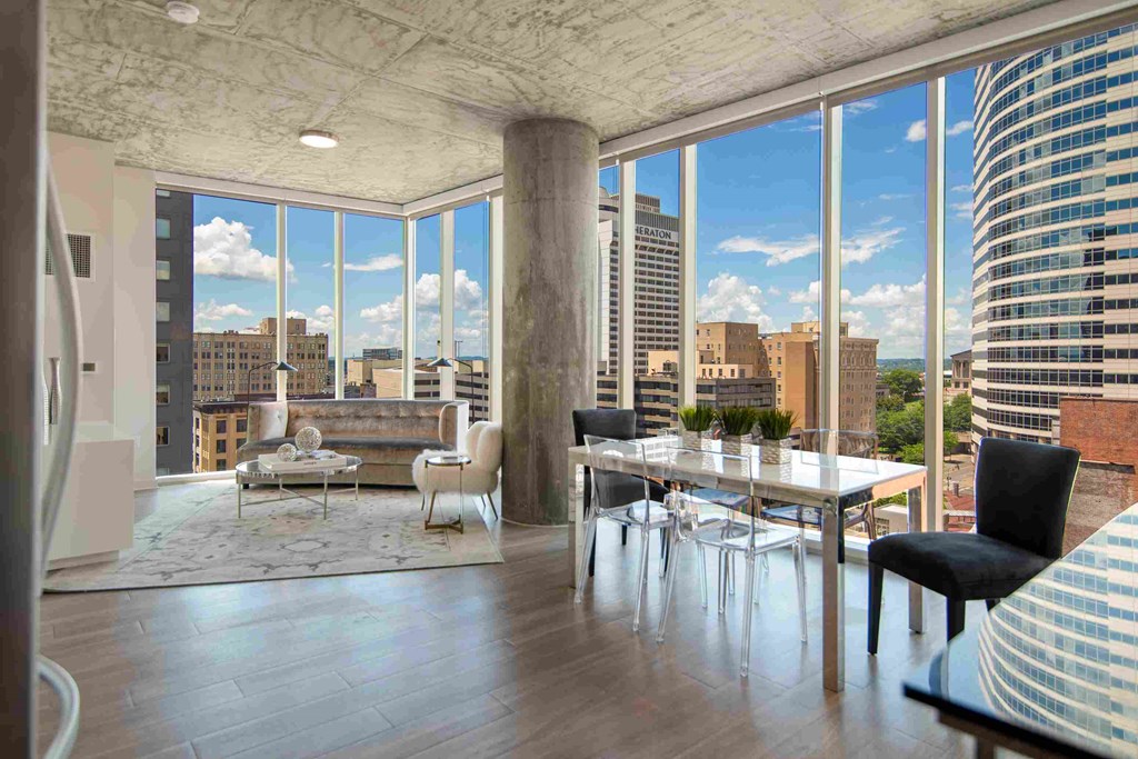 a view of the city from a living room with a table and chairs
