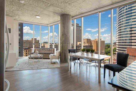 a view of the city from a living room with a table and chairs
