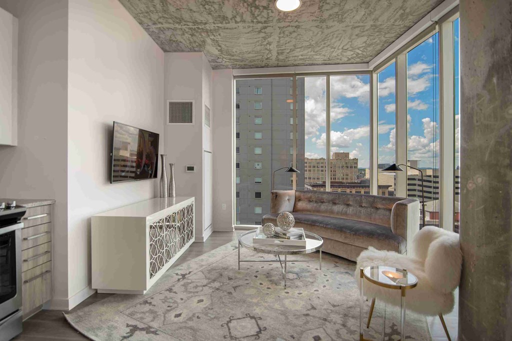 a rendering of a living room with a couch and a view of the city