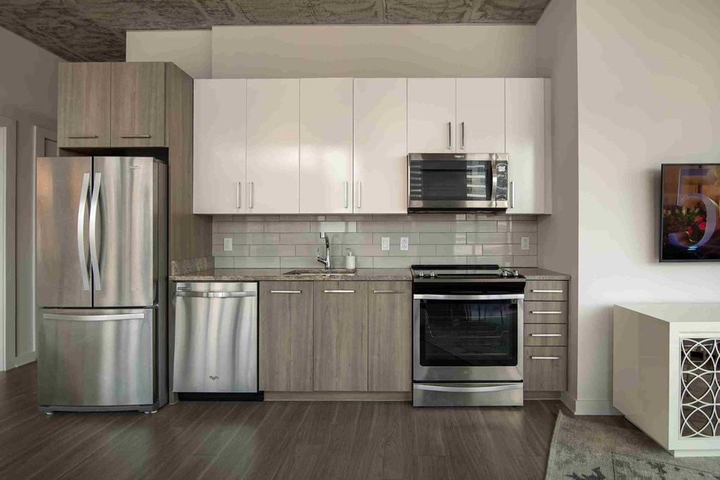 a kitchen with stainless steel appliances and white cabinets