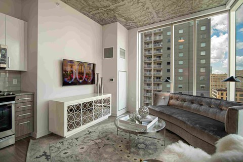 a living room with a couch and a large window