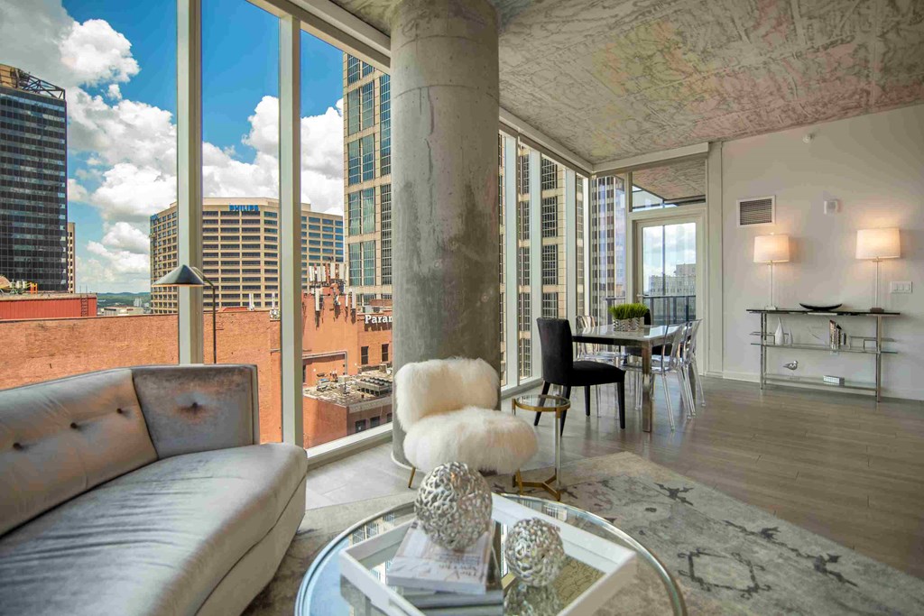 a view of the city from a living room with a couch and a table