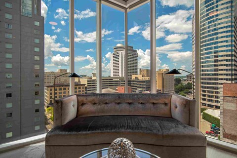 a living room with a couch and a view of the city
